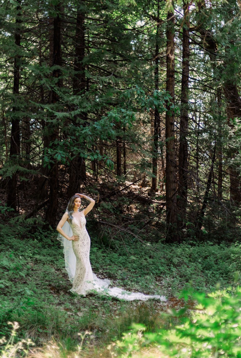 Romantic woodland wedding photos capturing movement and light through forest trees.