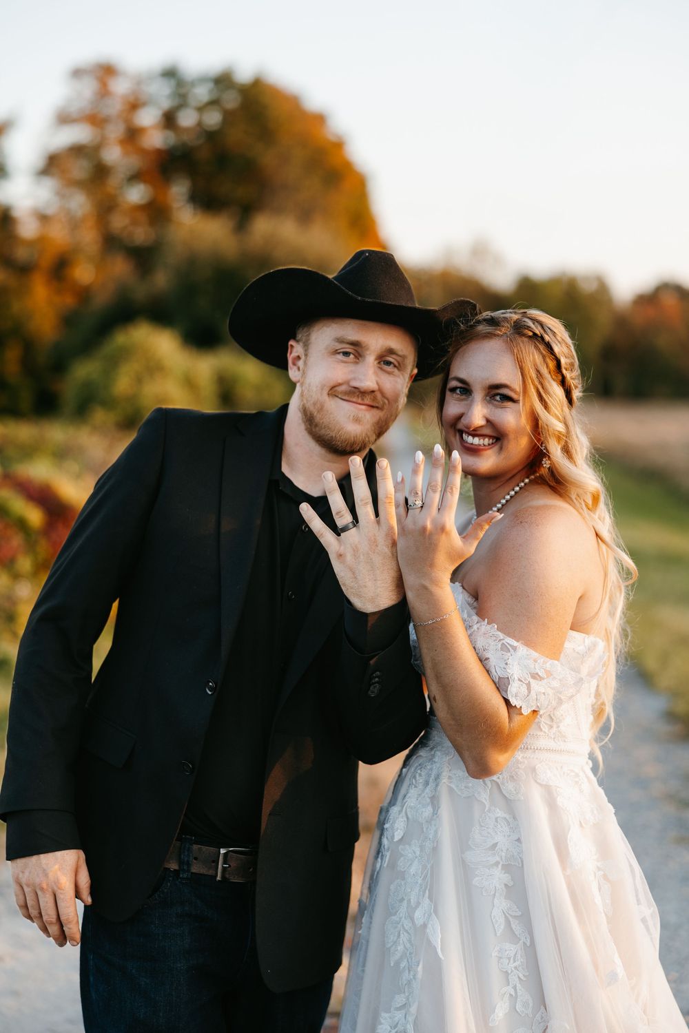 A couple in wedding attire shows off their rings in a series of romantic sunset photos outdoors.