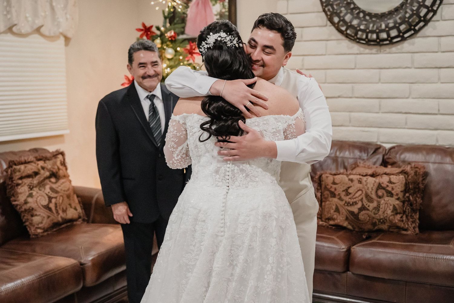 Wedding ceremony in an elegant room with white brick walls and decorative mirrors.