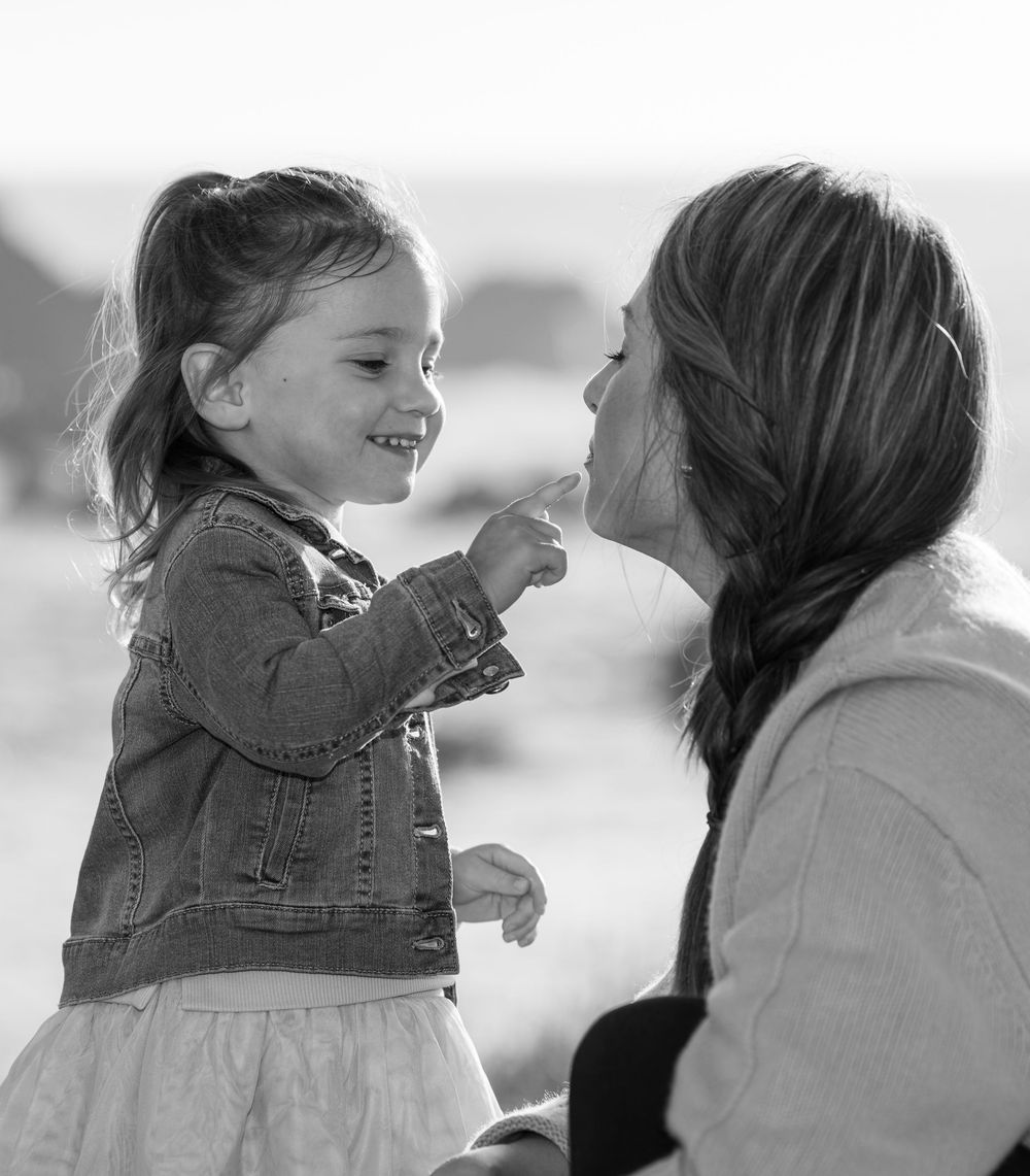 Black and white portrait series showing joyful interaction between parent and child.