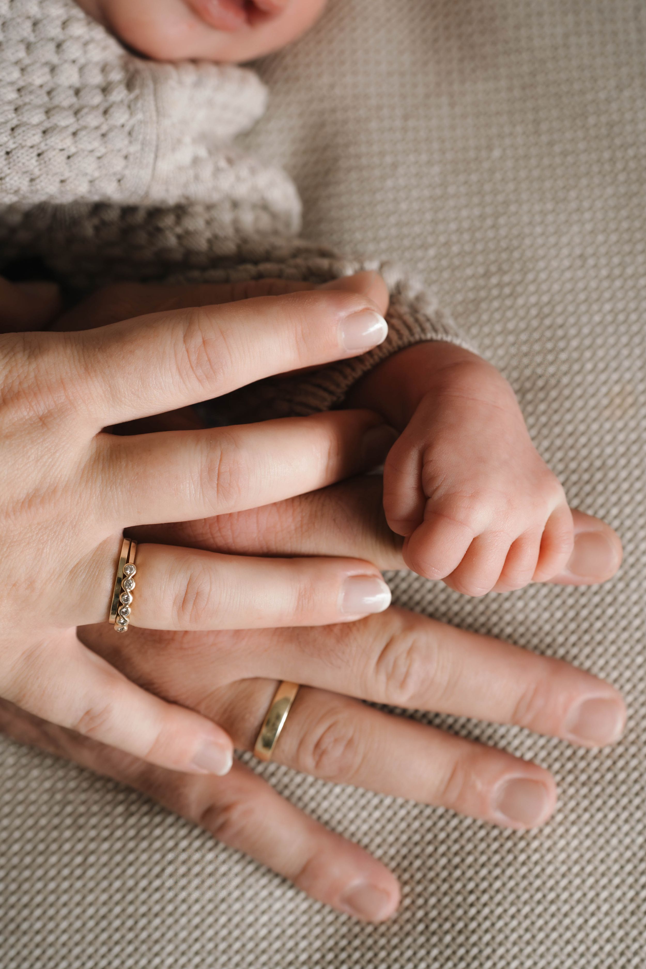 Newborn hands and parents