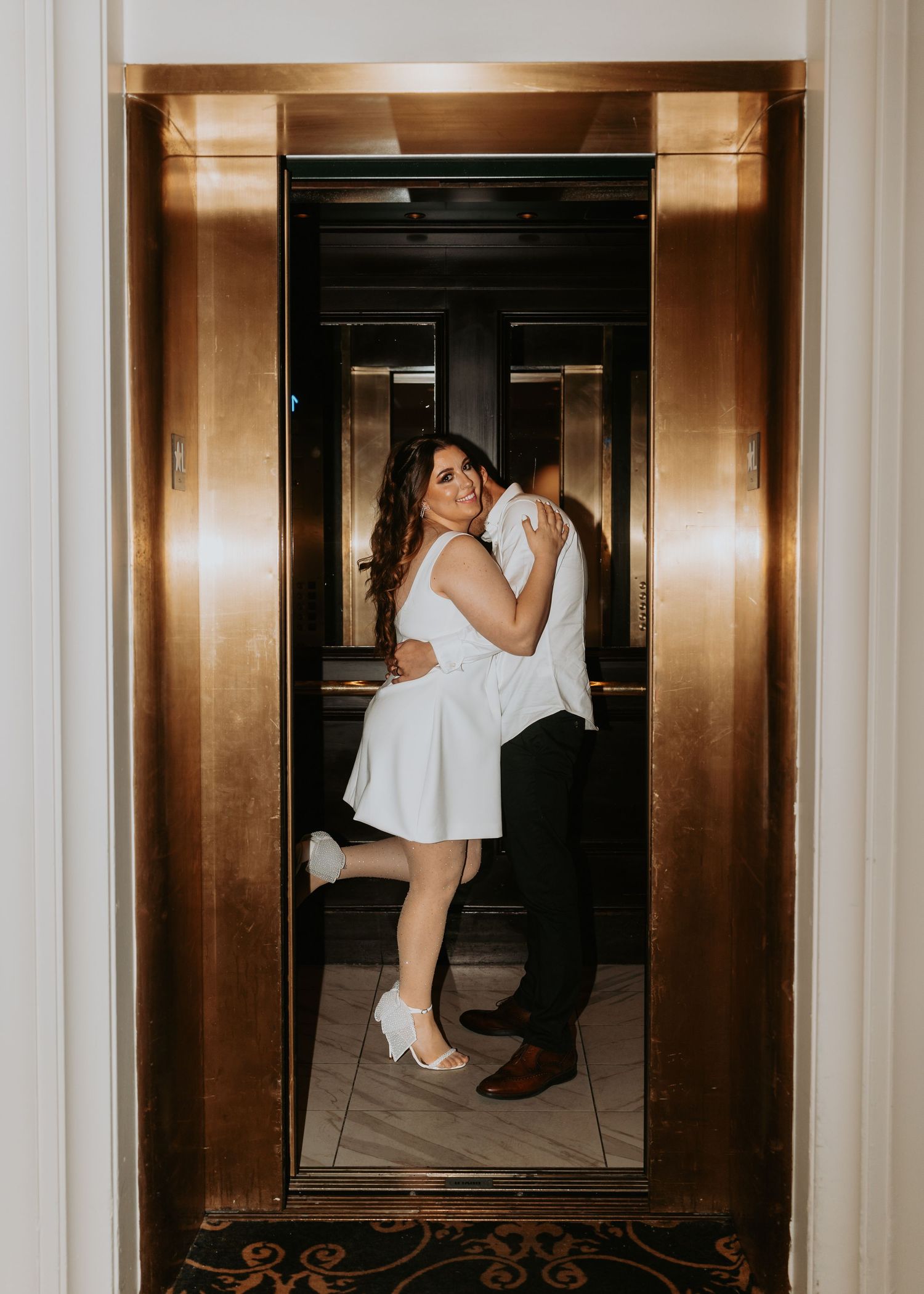 A sequence of four elevator photos showing a couple in formal attire embracing and dancing in an elegant gold-toned interior.