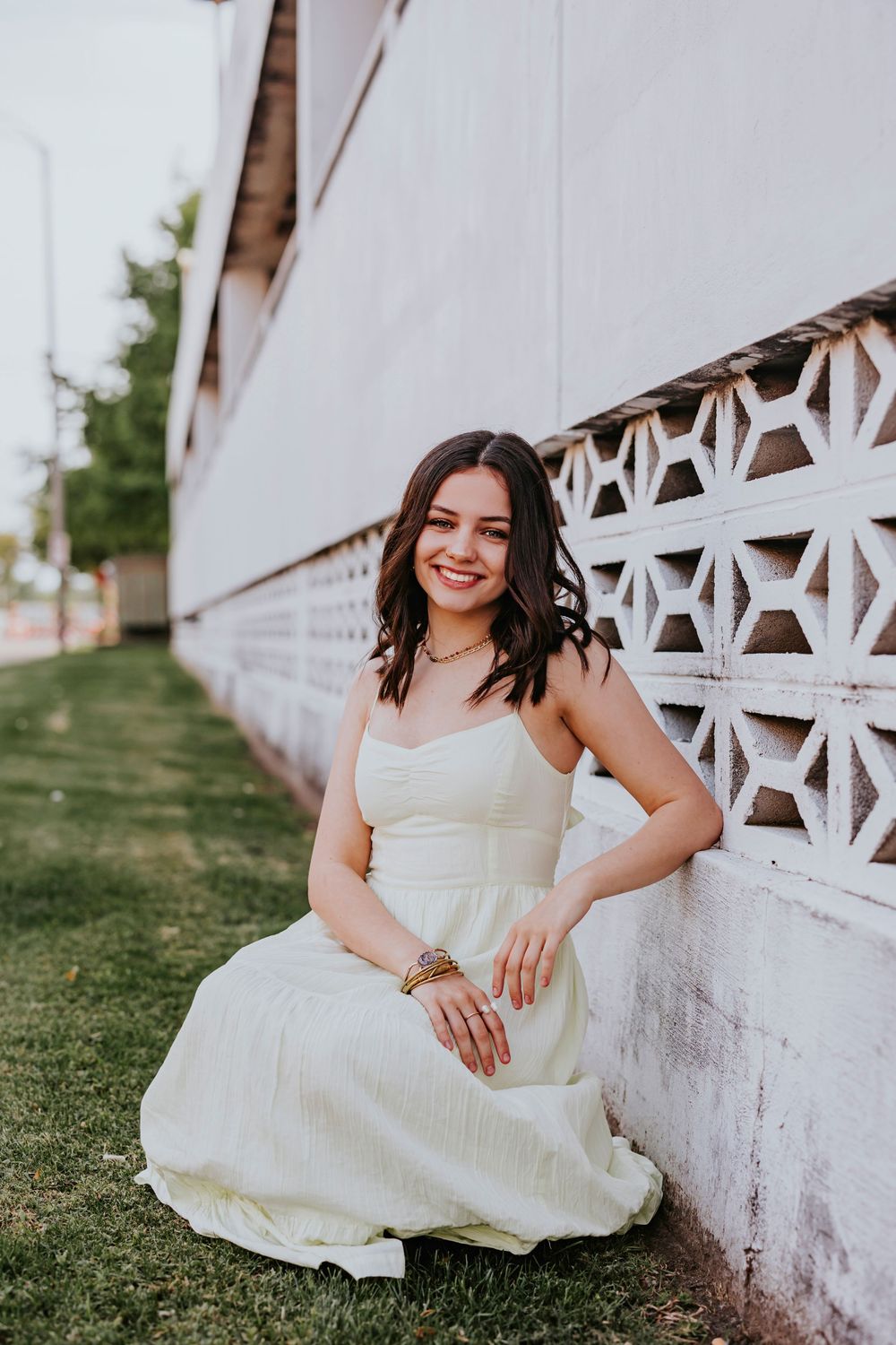 Elegant portraits against a white decorative wall featuring vintage architectural details.