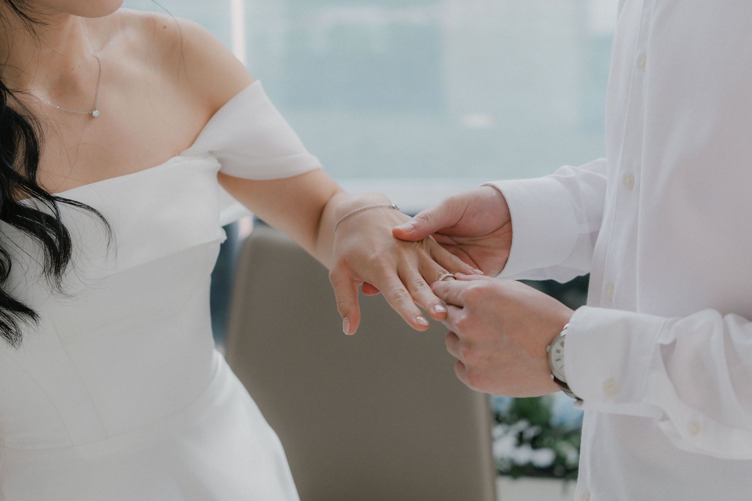 Close-up of a ring exchange moment during a wedding ceremony.