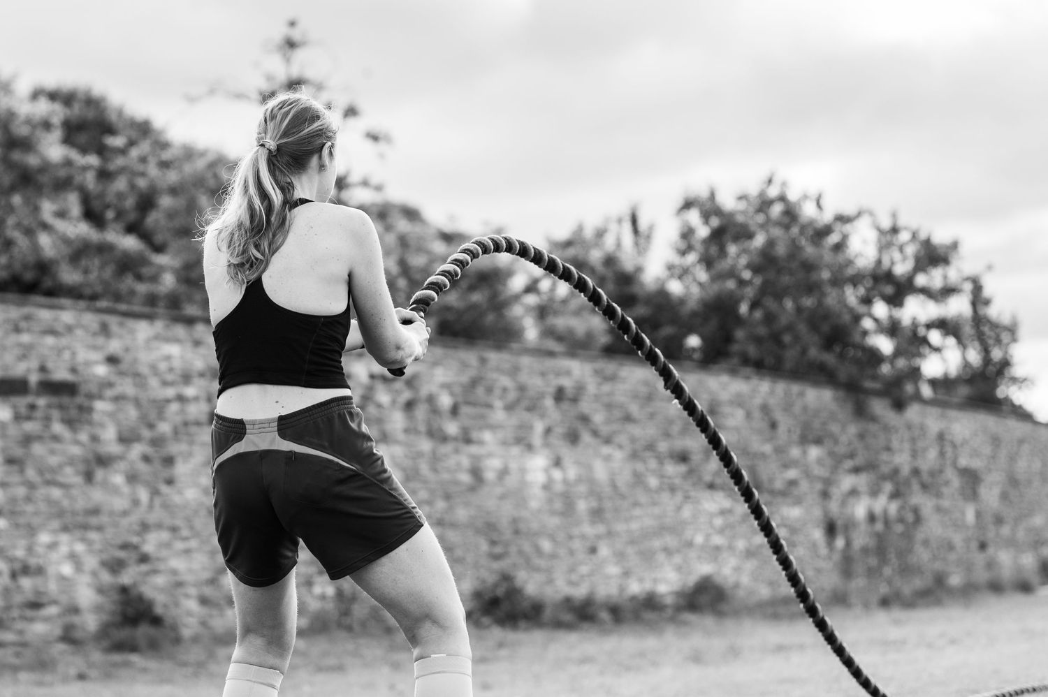 Close-up details of casual outdoor fitness attire and exercise equipment shown in black and white.