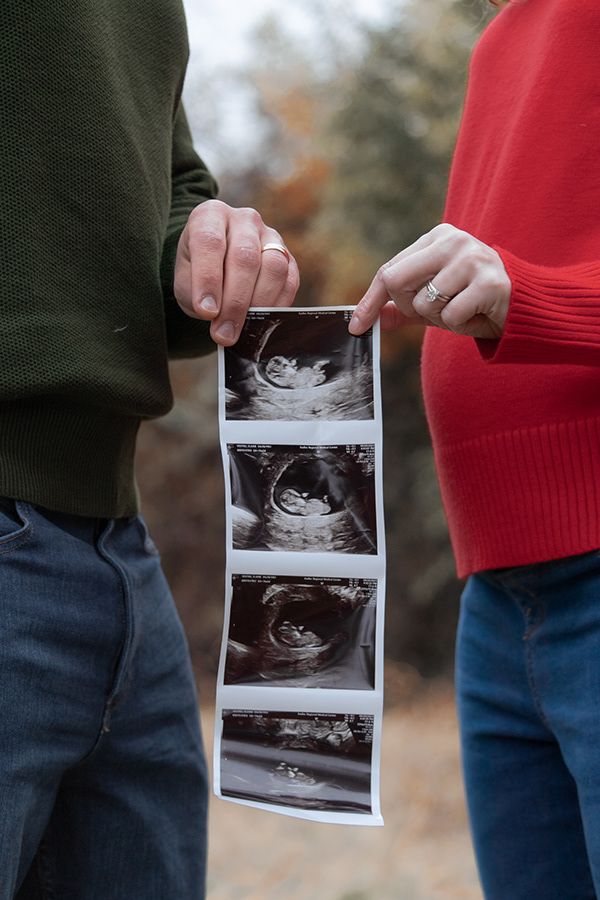 Couple holding sonogram strip during pregnancy announcement session in Tri-Cities WA