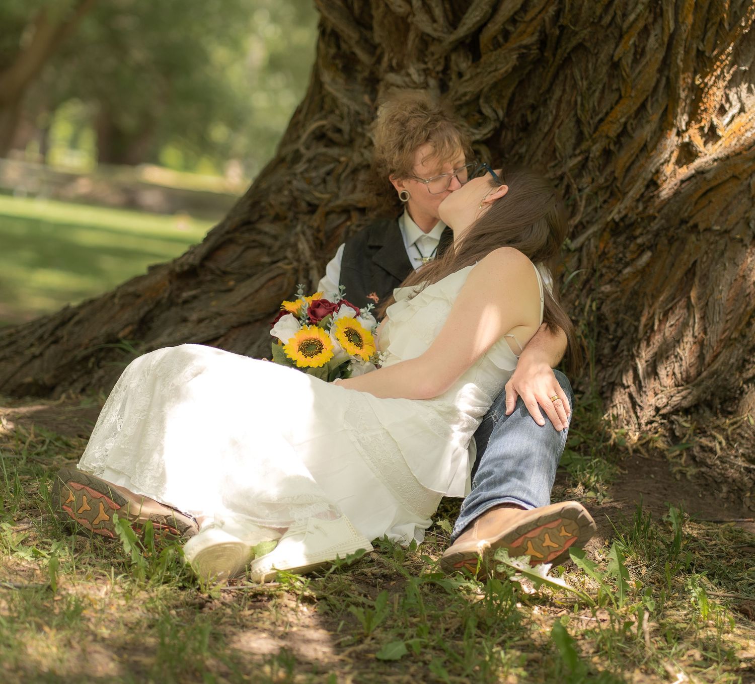 Happy wedding couple kissing in Logan UT Park.