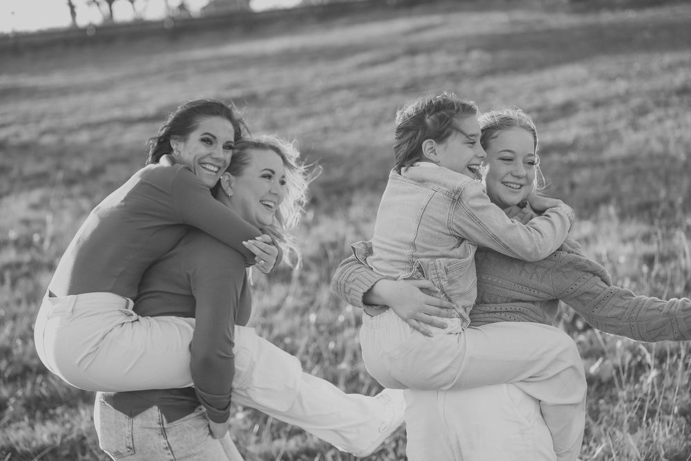Cousins in a piggy back ride laughting together
