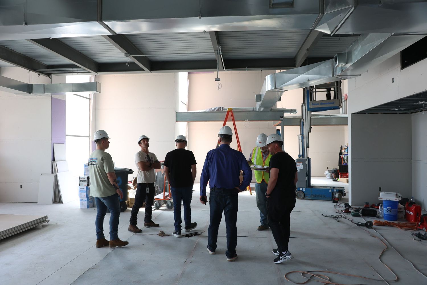 Clients inspecting Detroit construction site, documenting progress and collaboration, by Aerial Detroit drone team.