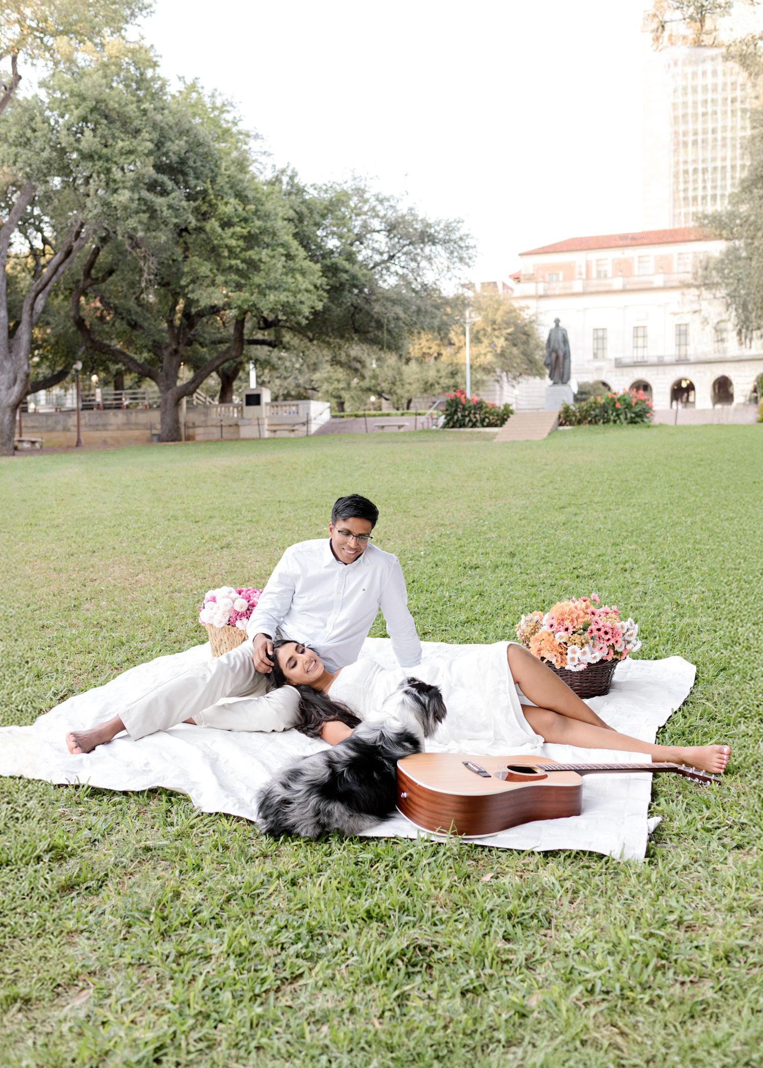 Three photos show a couple laying on a white blanket in a grassy area with a guitar, creating romantic outdoor portraits.