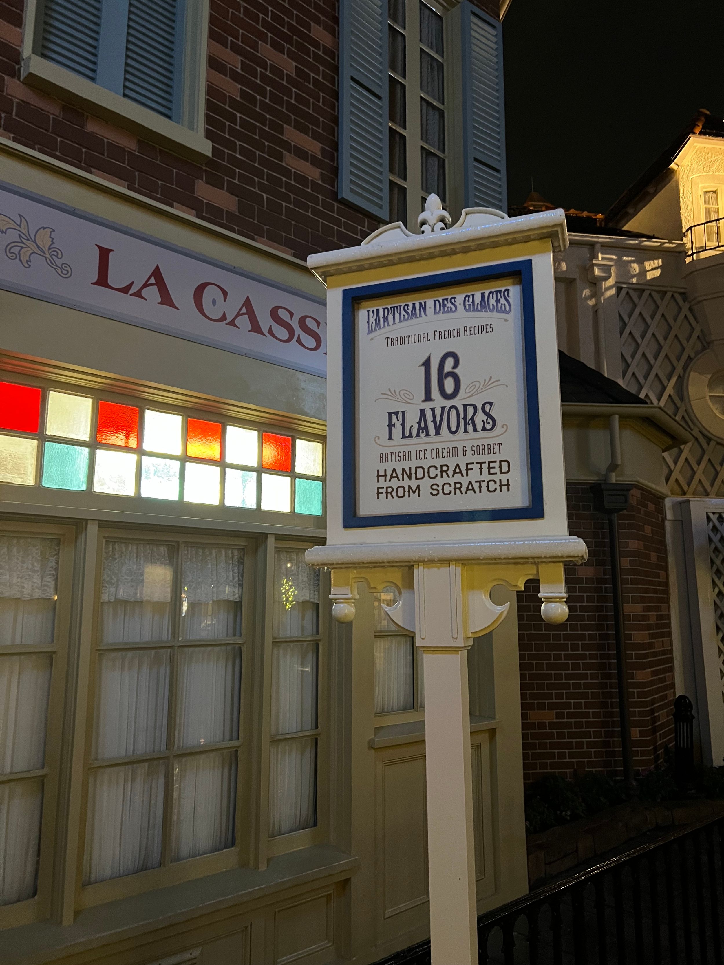 A vintage-style storefront sign advertising 16 flavors of handmade ice cream.