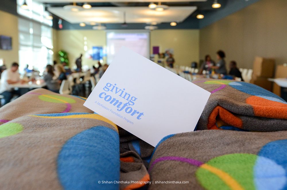 Status report card laying on colorful patterned blanket or textile surface.