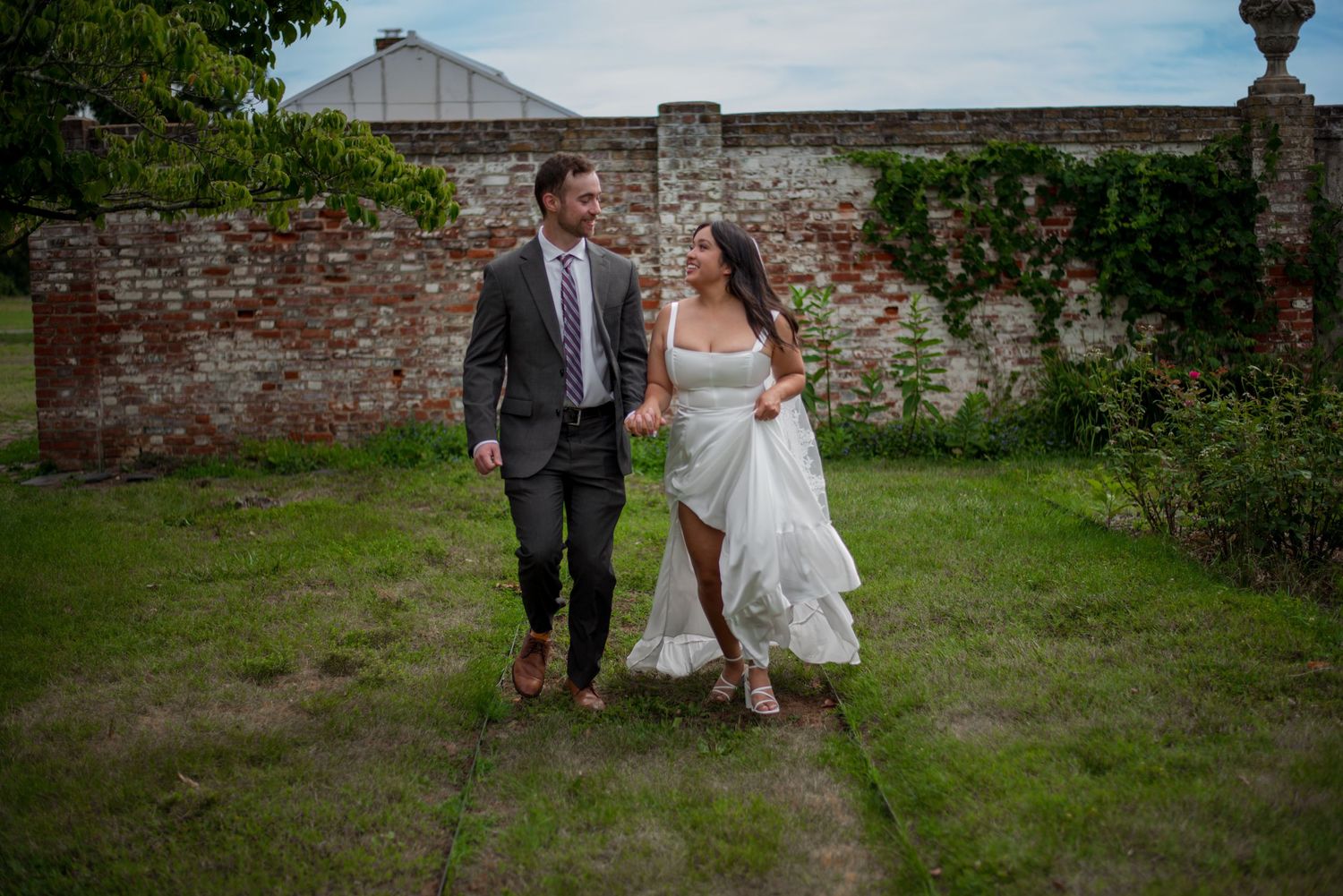 Bride and groom running, and smiling on wedding day