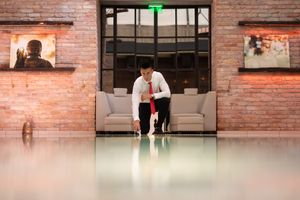 A series of brick-walled office spaces and corridors with modern industrial design elements and glass partitions.
