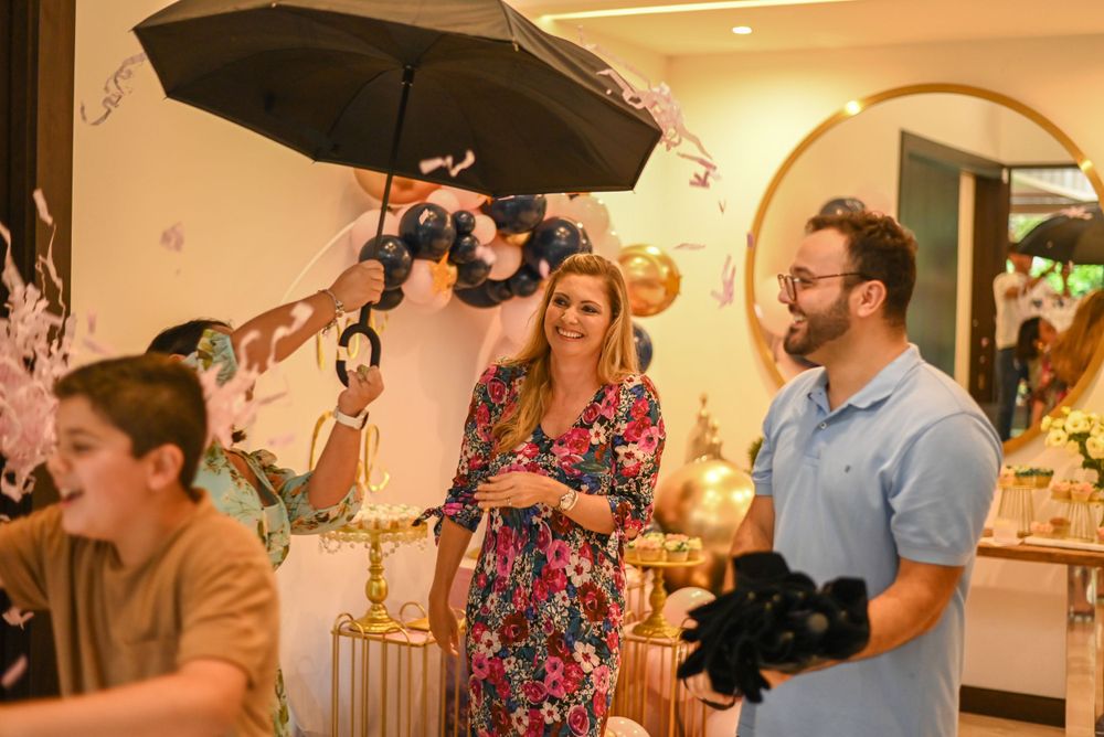 A film crew with cameras and lighting equipment captures a scene in an indoor setting with ornate decor.