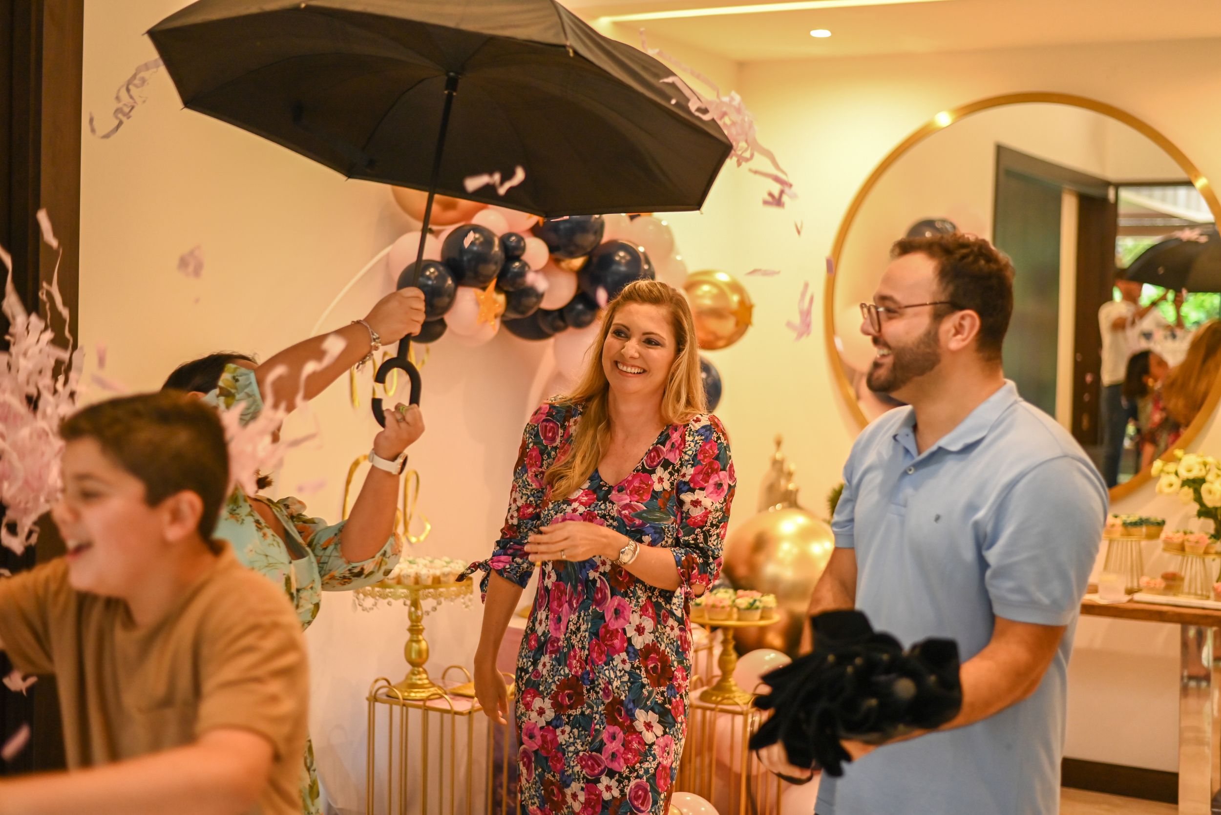 A film crew with cameras and lighting equipment captures a scene in an indoor setting with ornate decor.