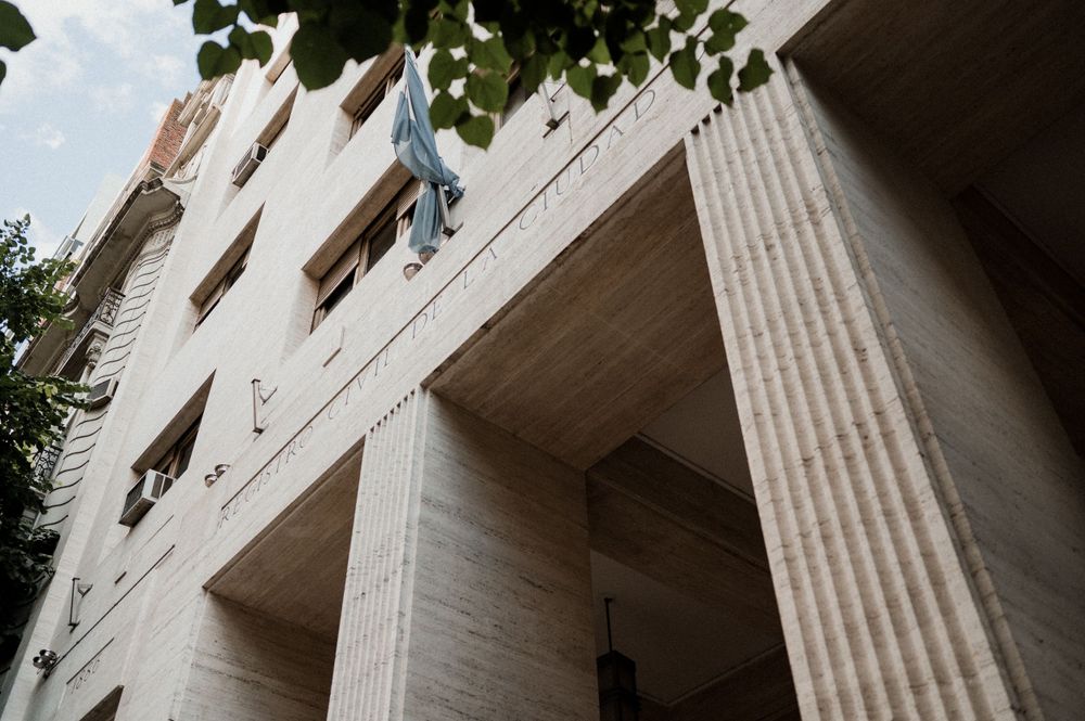An architectural view looking up at a classic building with columns and windows.