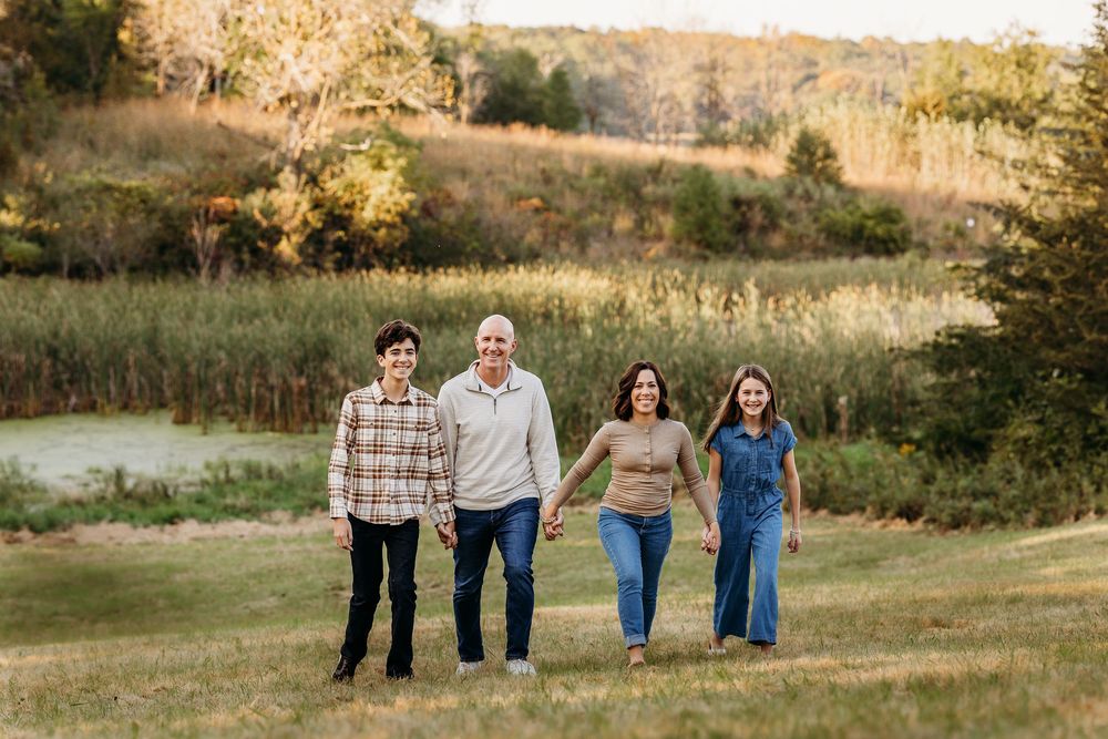 A series of outdoor family portraits taken in a golden field at sunset with natural lighting and autumn scenery.