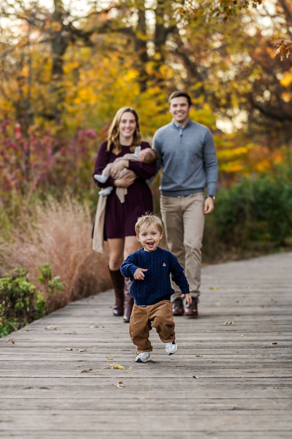 A sequence of candid moments captured on a wooden boardwalk surrounded by autumn foliage during golden hour.