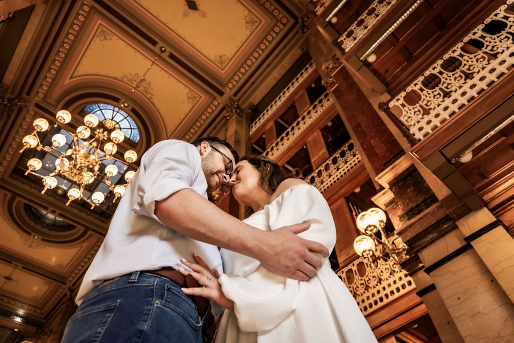 Low angle on a couple embracing within the library during their engagement session