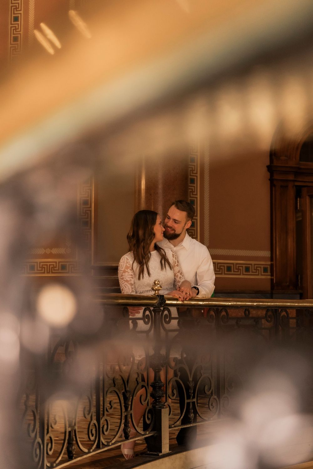 Engaged Couple talking at the balcony during their engagement session with A.West Photography.