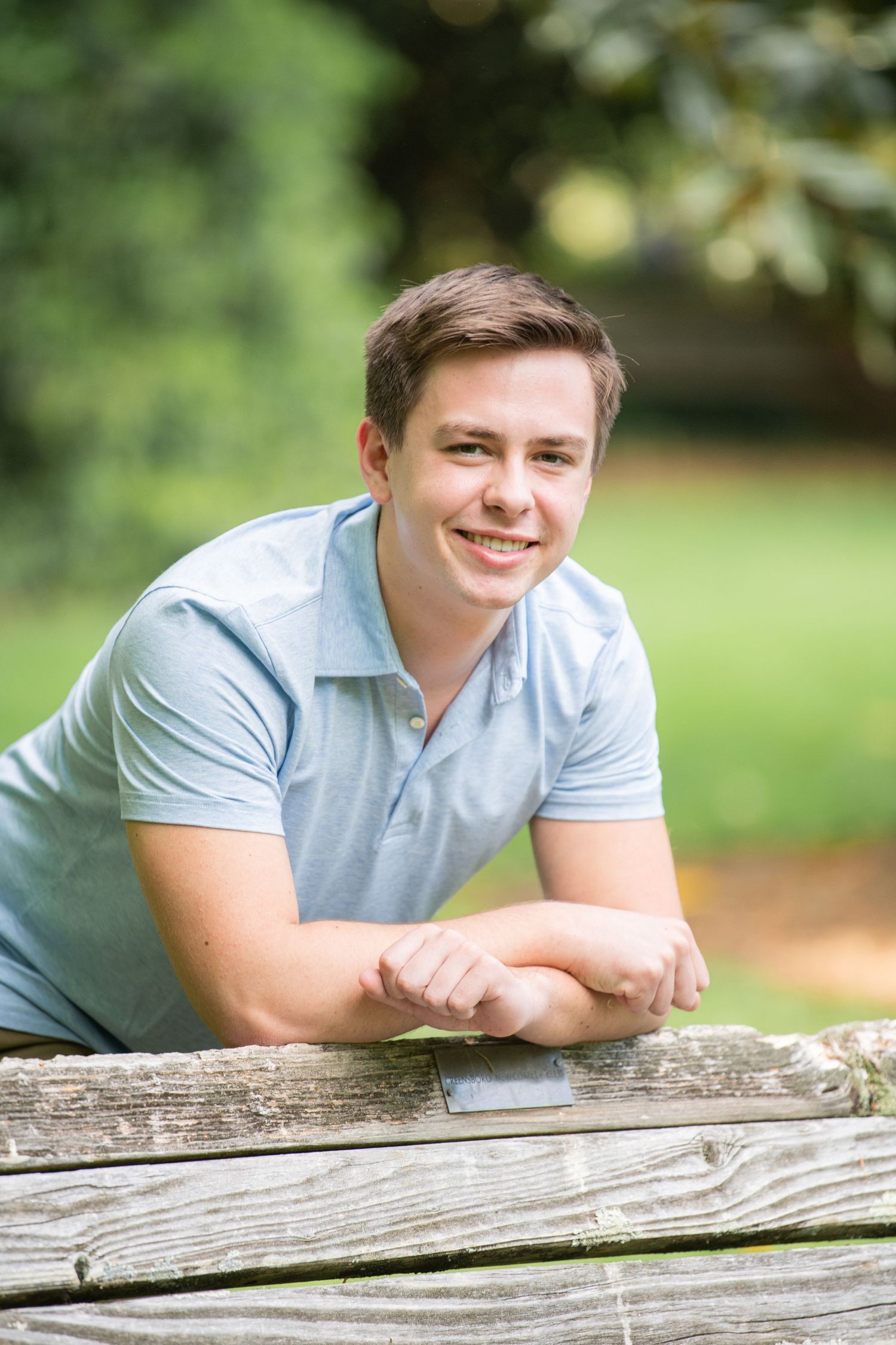 A senior boy posing confidently in an outdoor photo session, capturing timeless and stylish memories in a natural setting!