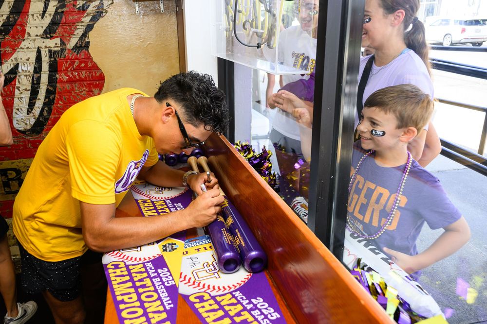 People gathering around a glass display counter at a retail store looking at colorful merchandise and collectibles.