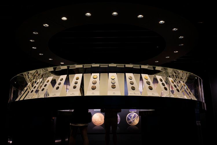 Circular display of illuminated architectural elements creates dramatic ceiling pattern.