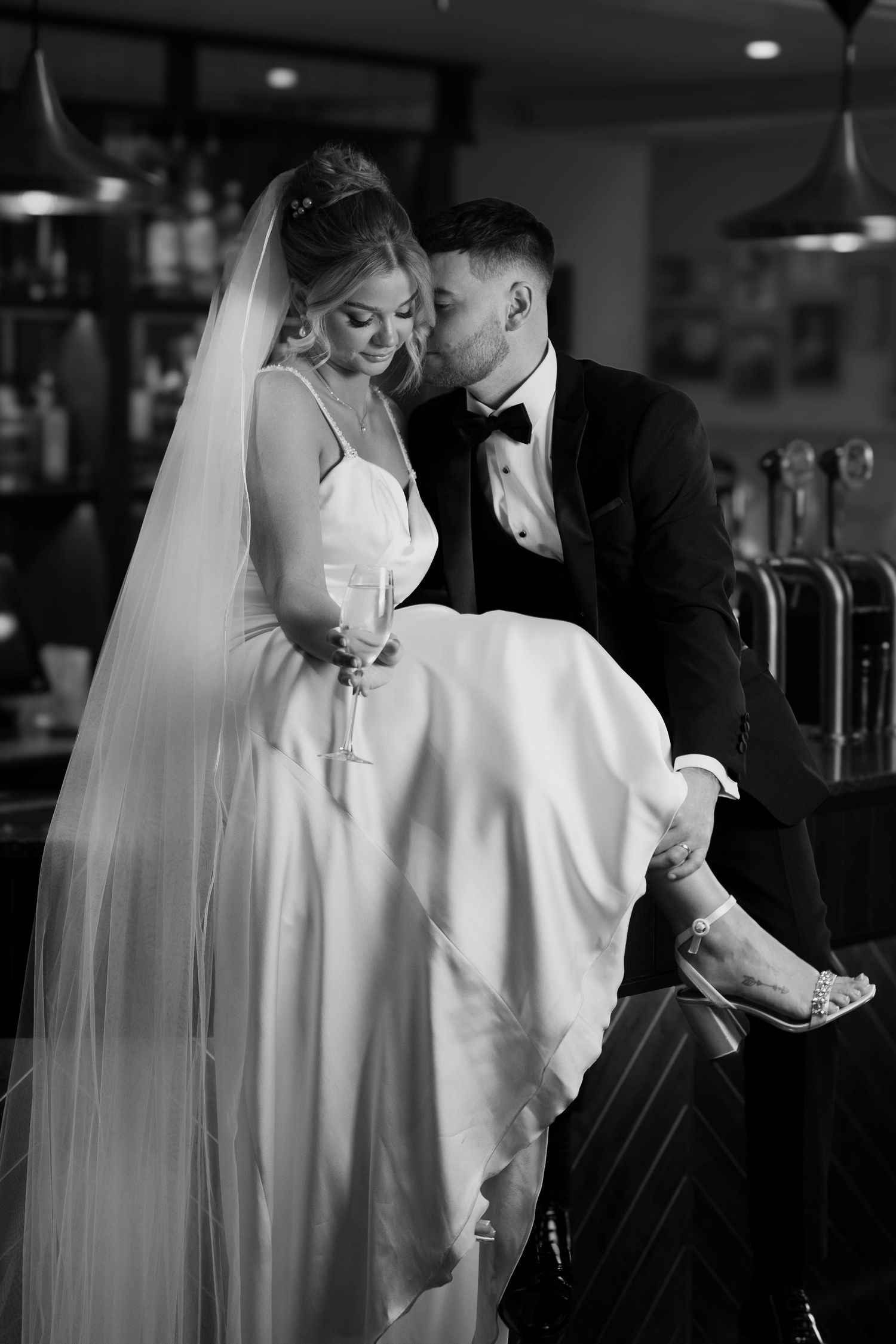 A romantic black and white sequence of a couple in wedding attire sharing intimate moments.