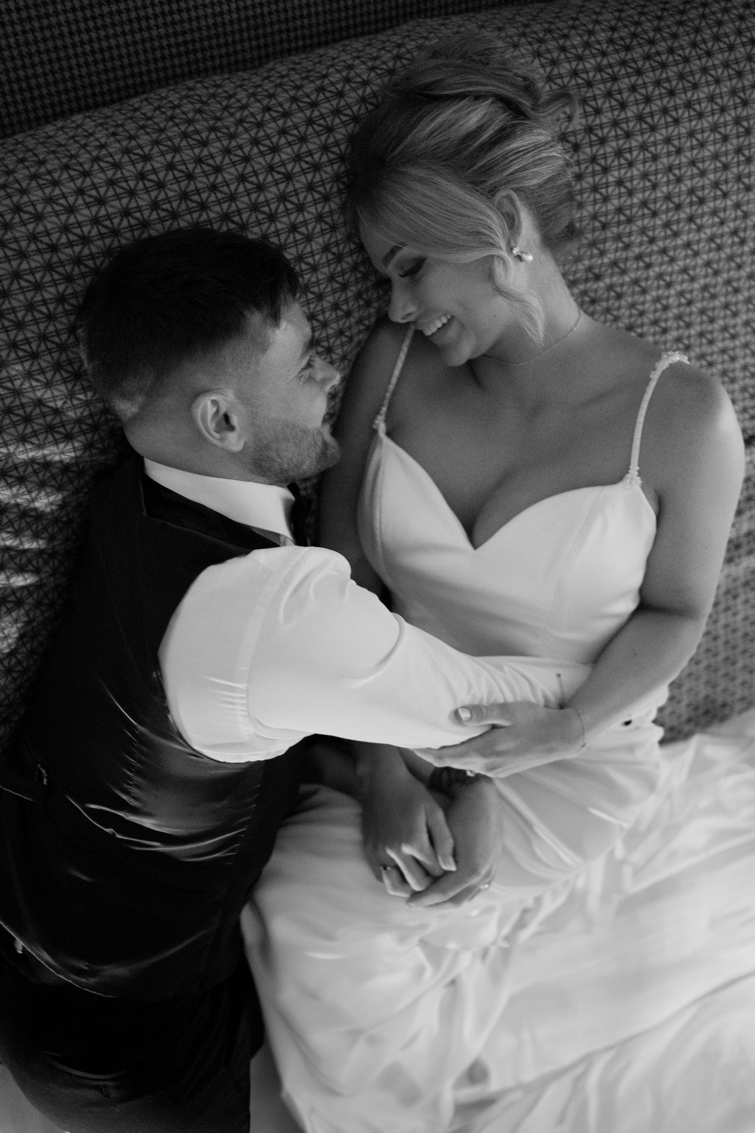 Artistic black and white photo series showing tender moments between a couple lying down.