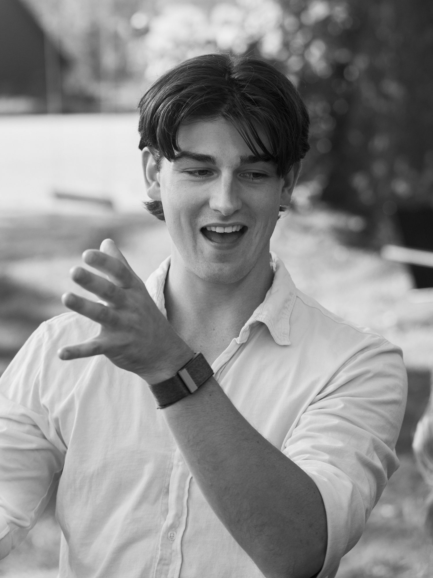 A black and white portrait showing joy and laughter outdoors.