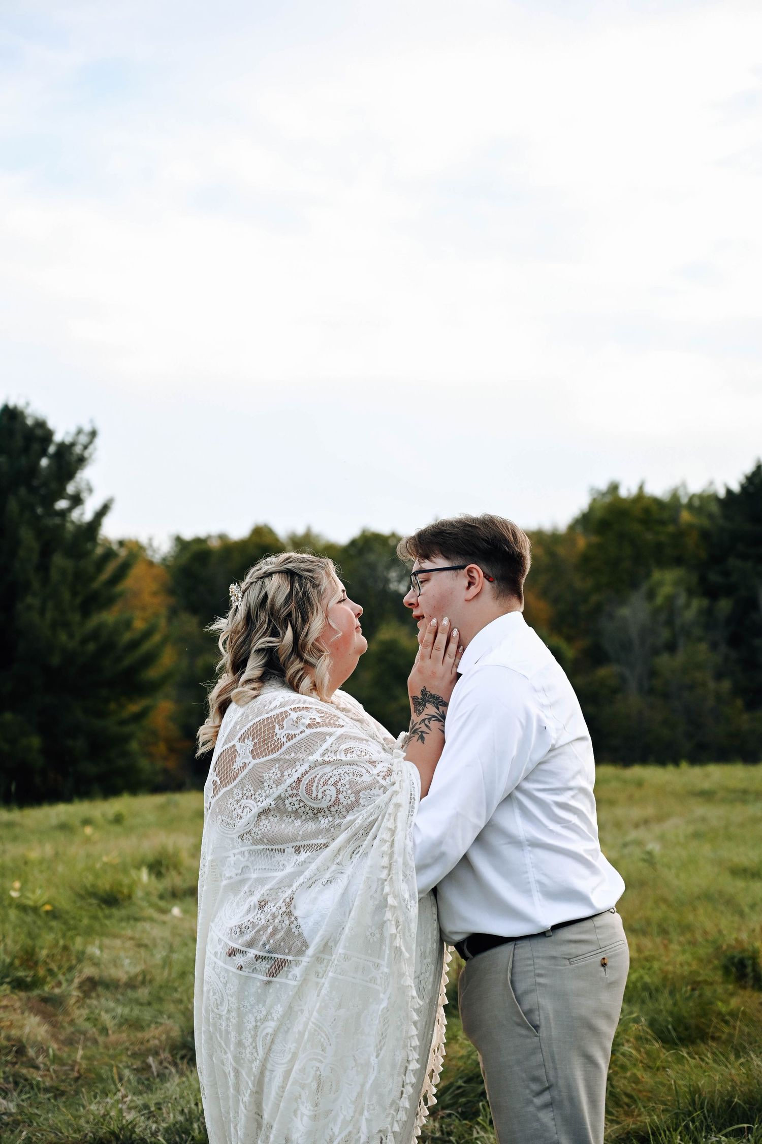 Emotional moment shared between couple during outdoor countryside photo session.