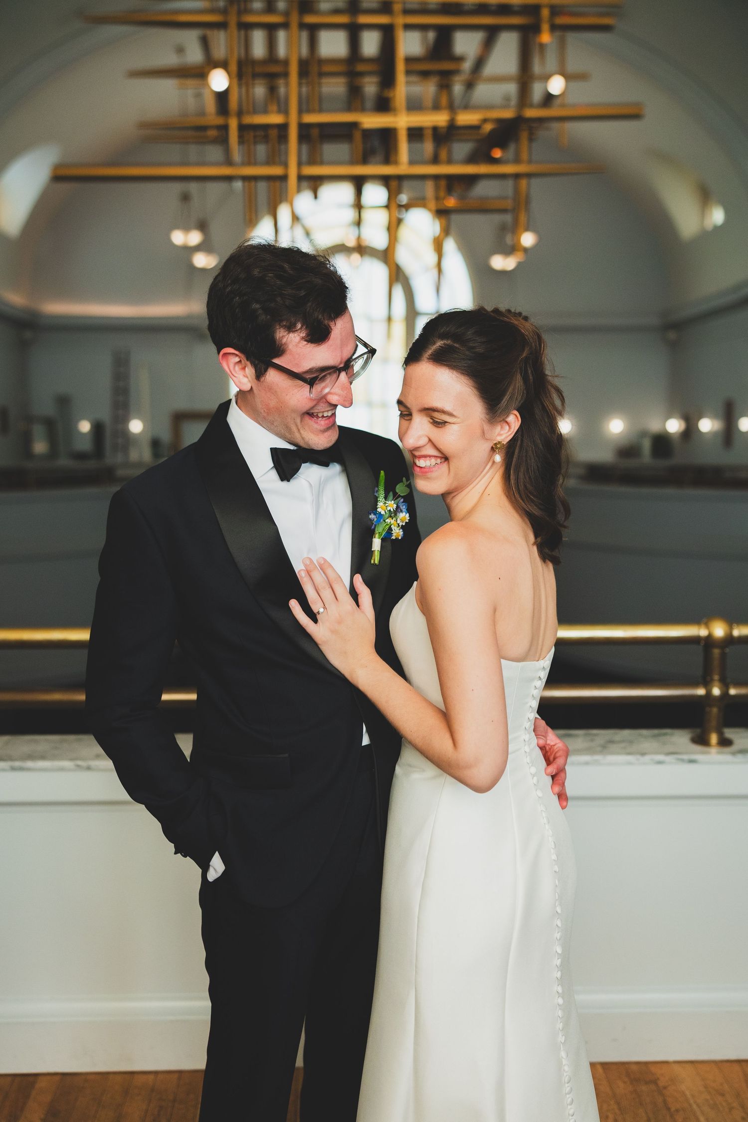 A happy couple shares a joyful moment together at the line DC hotel in washington dc, with elegant lighting and decor in the background.