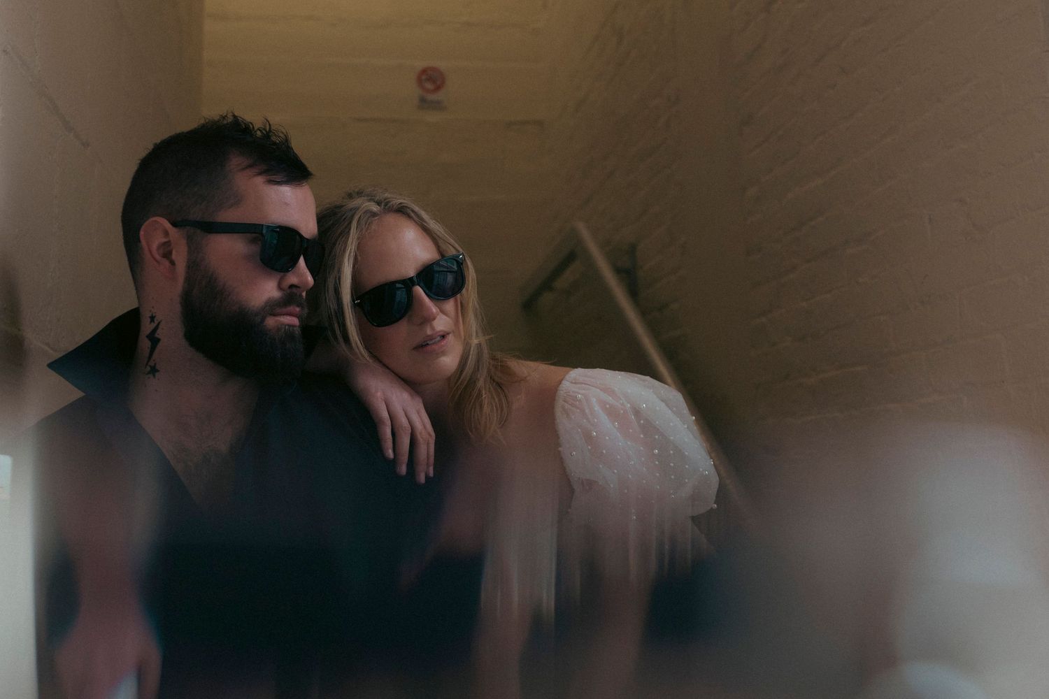 A couple in sunglasses smiles together in a series of candid photo booth style snapshots.