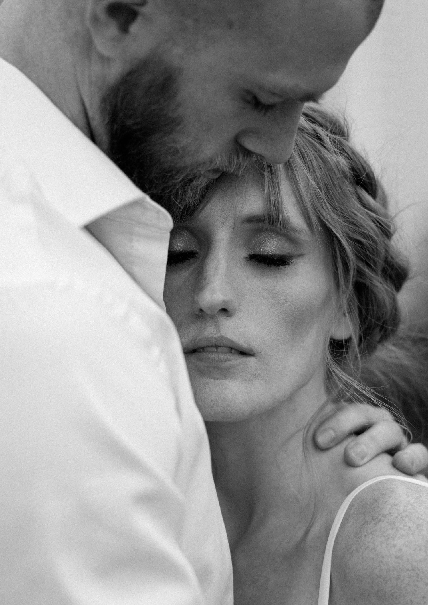 A romantic black and white photo sequence showing a couple sharing tender kisses and intimate moments.