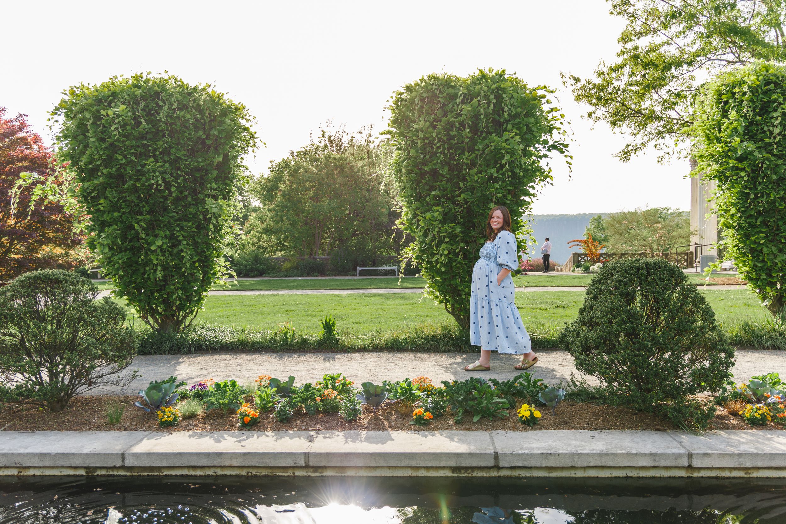 Outdoor garden wedding venue with stone pathway and lush greenery.