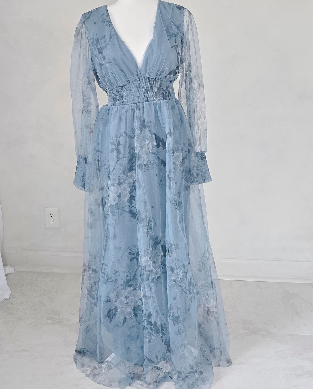 Light blue floral chiffon maxi dress with sheer long sleeves, ruffle details and empire waist design.