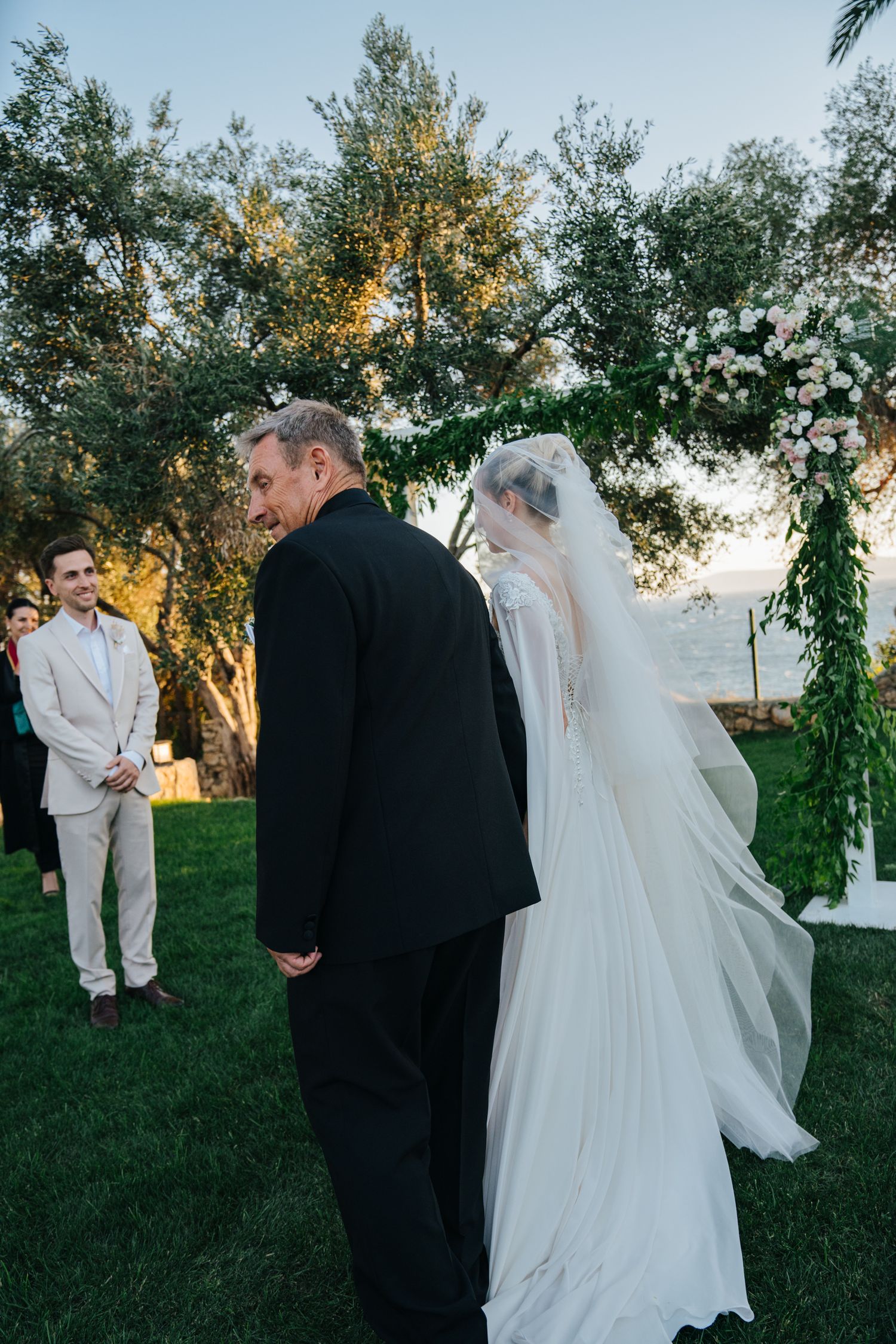 A wedding ceremony sequence captured outdoors with a white-gowned bride and dark-suited groom under sunlit trees.