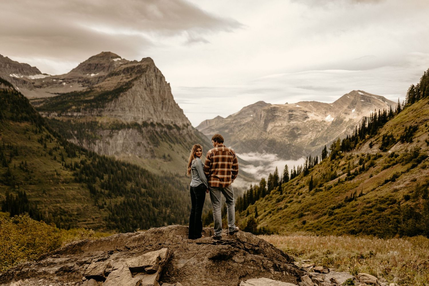 Dramatic mountain landscape with two figures enjoying the scenic mountain vista at dusk.