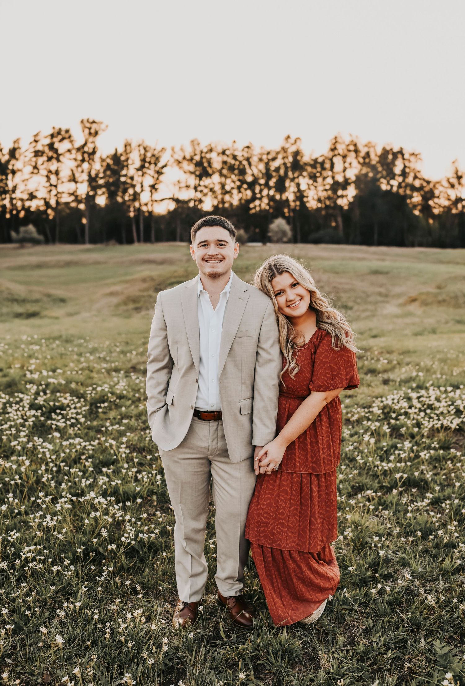 Engagement session at Grapevine Lake with sunset light and open field.