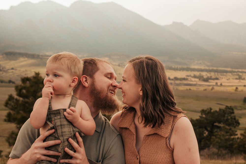 Family sharing a joyful moment together in a golden field at sunset |What to Wear for Family Photos