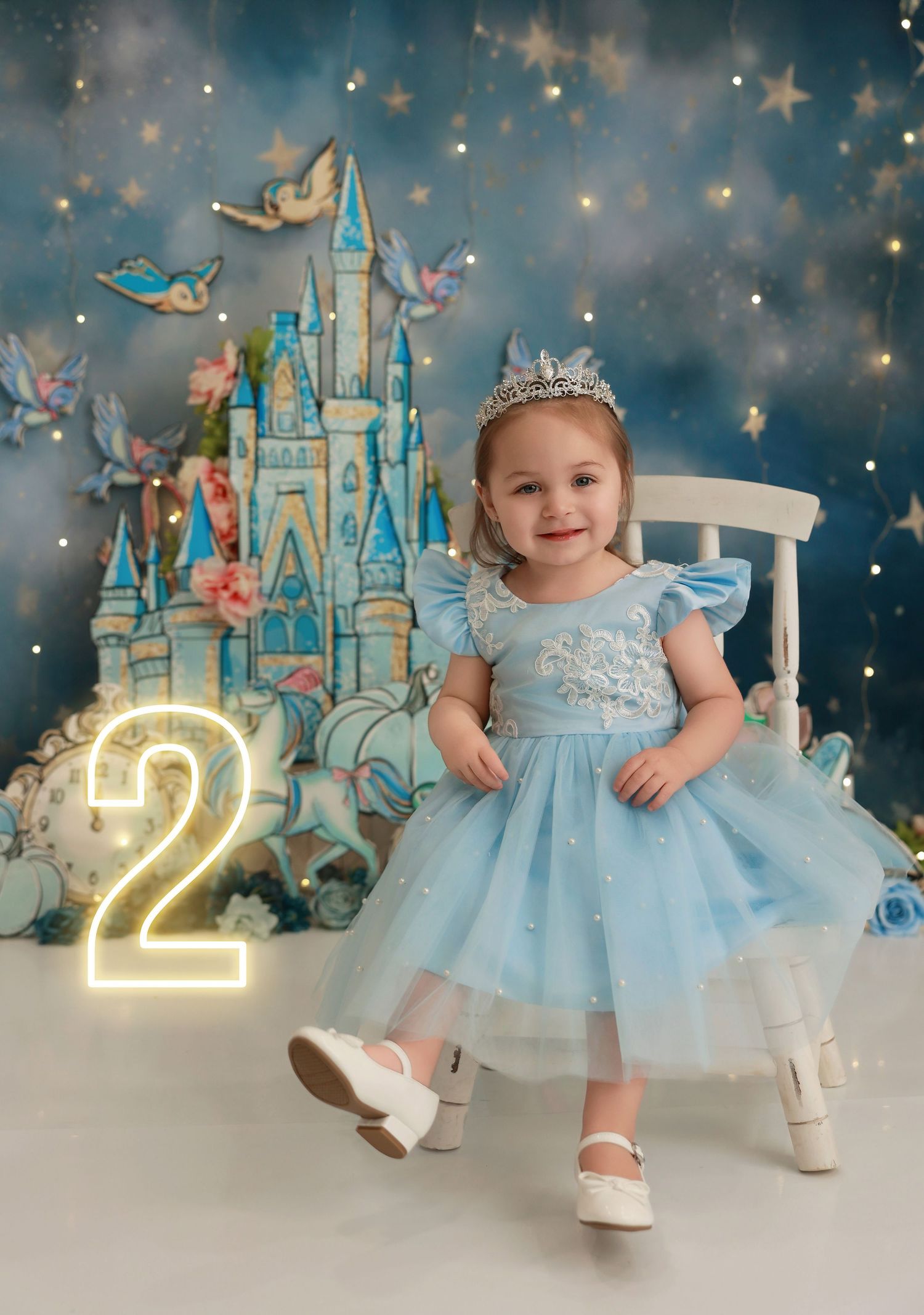 Magical birthday photo series with castle backdrop, twinkling lights, and light blue tulle dress against a dreamy starlit scene.