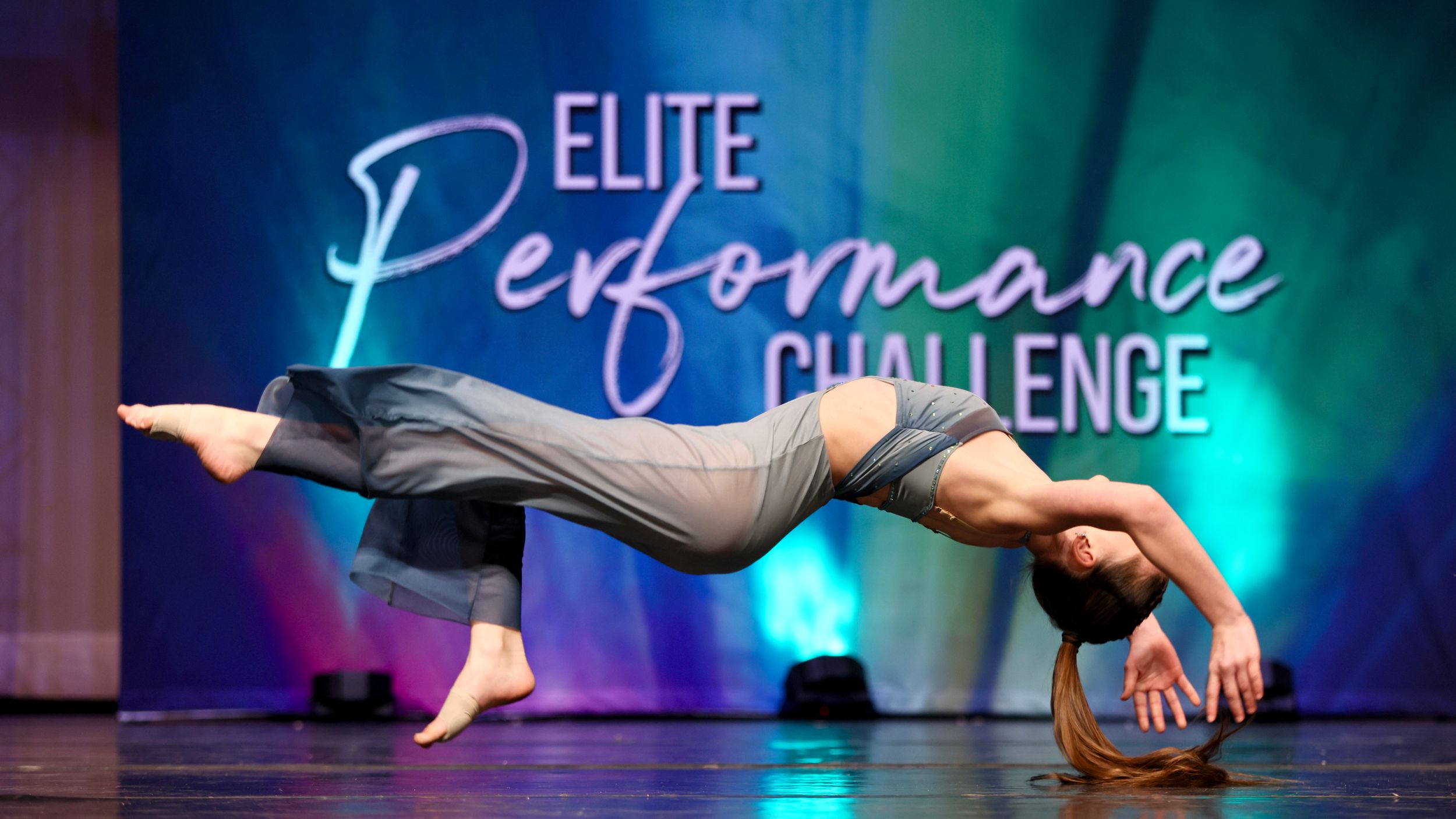 Flexible dancer performing a dramatic horizontal balance pose at Elite Performance Challenge.