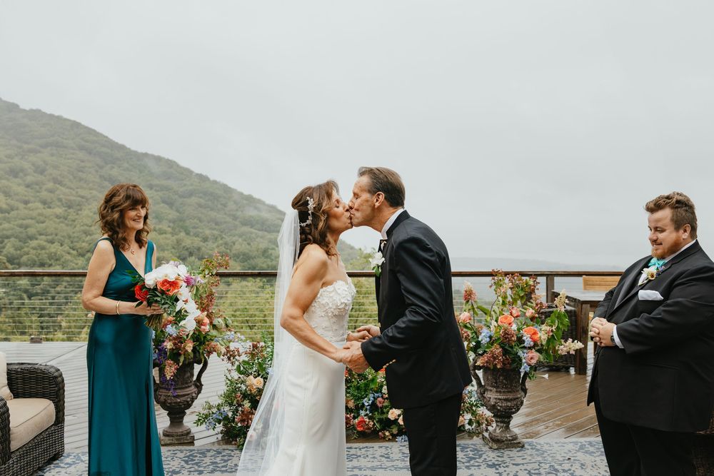 Wedding ceremony moments captured in a series of outdoor photos against a mountainous backdrop.