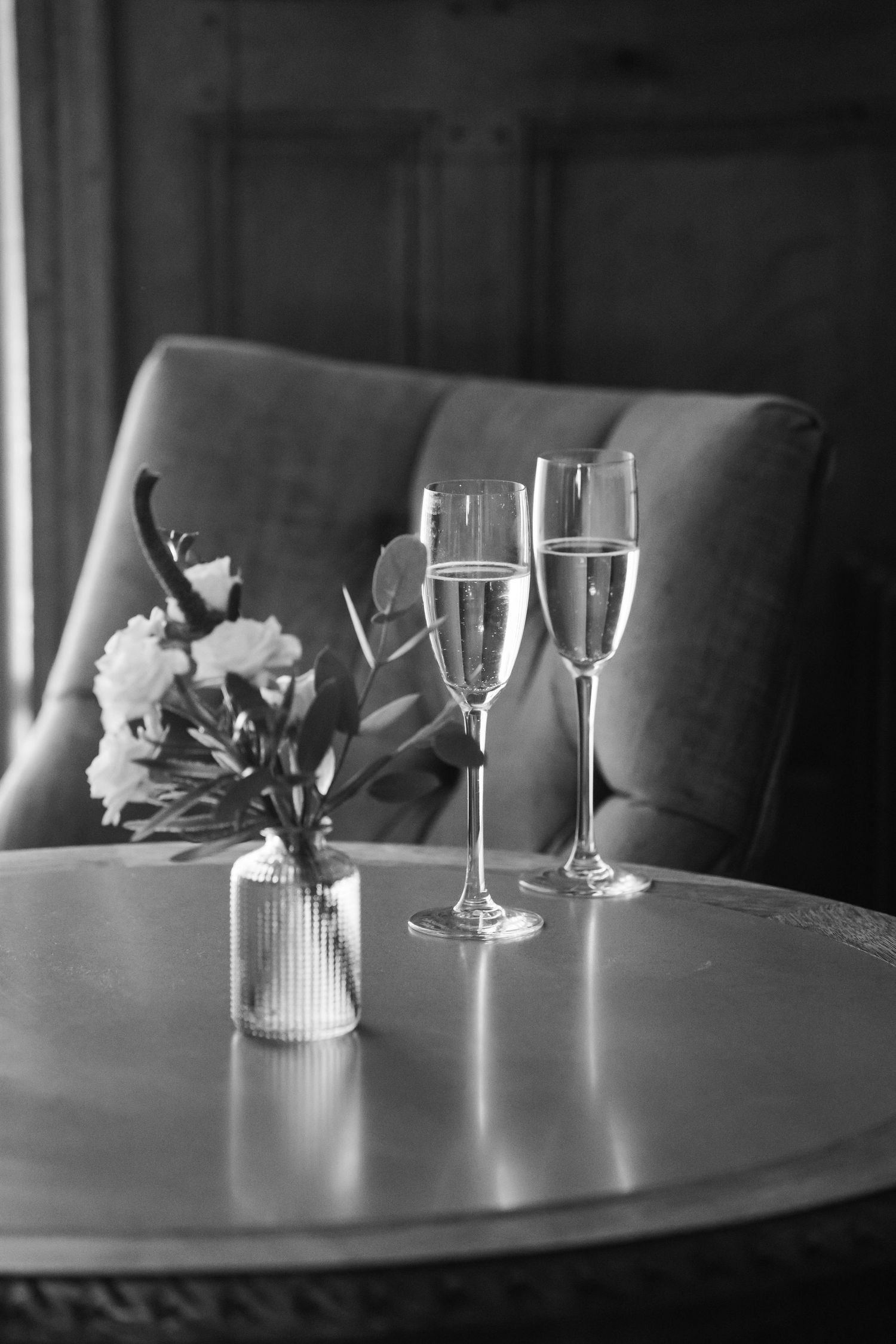 Zara Davis Wedding Photography Bristol Combe Lodge Cotswolds Cheltenham black and white photo of bouquet and champage