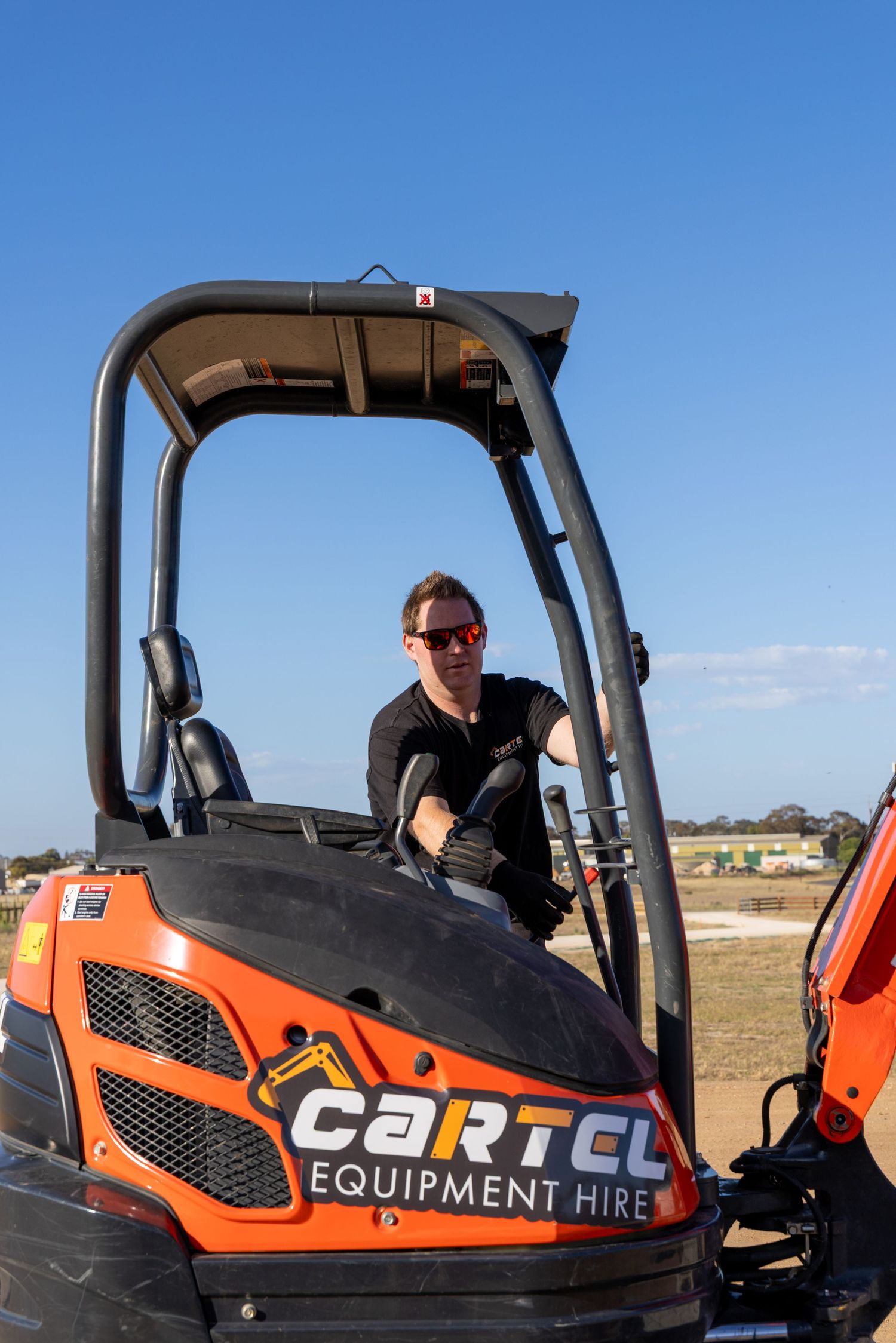 Operator using Cartel Equipment Hire mini excavator on job site