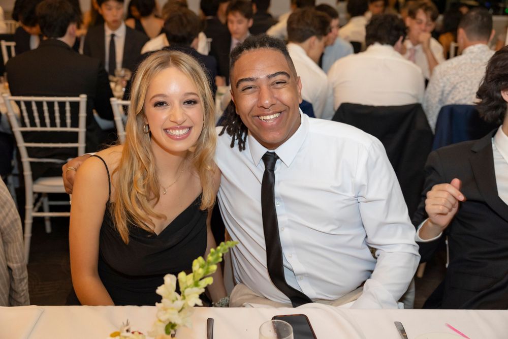 Sydney Event Photography - A festive formal dining scene with two attendees sharing a moment at an elegant table setting.