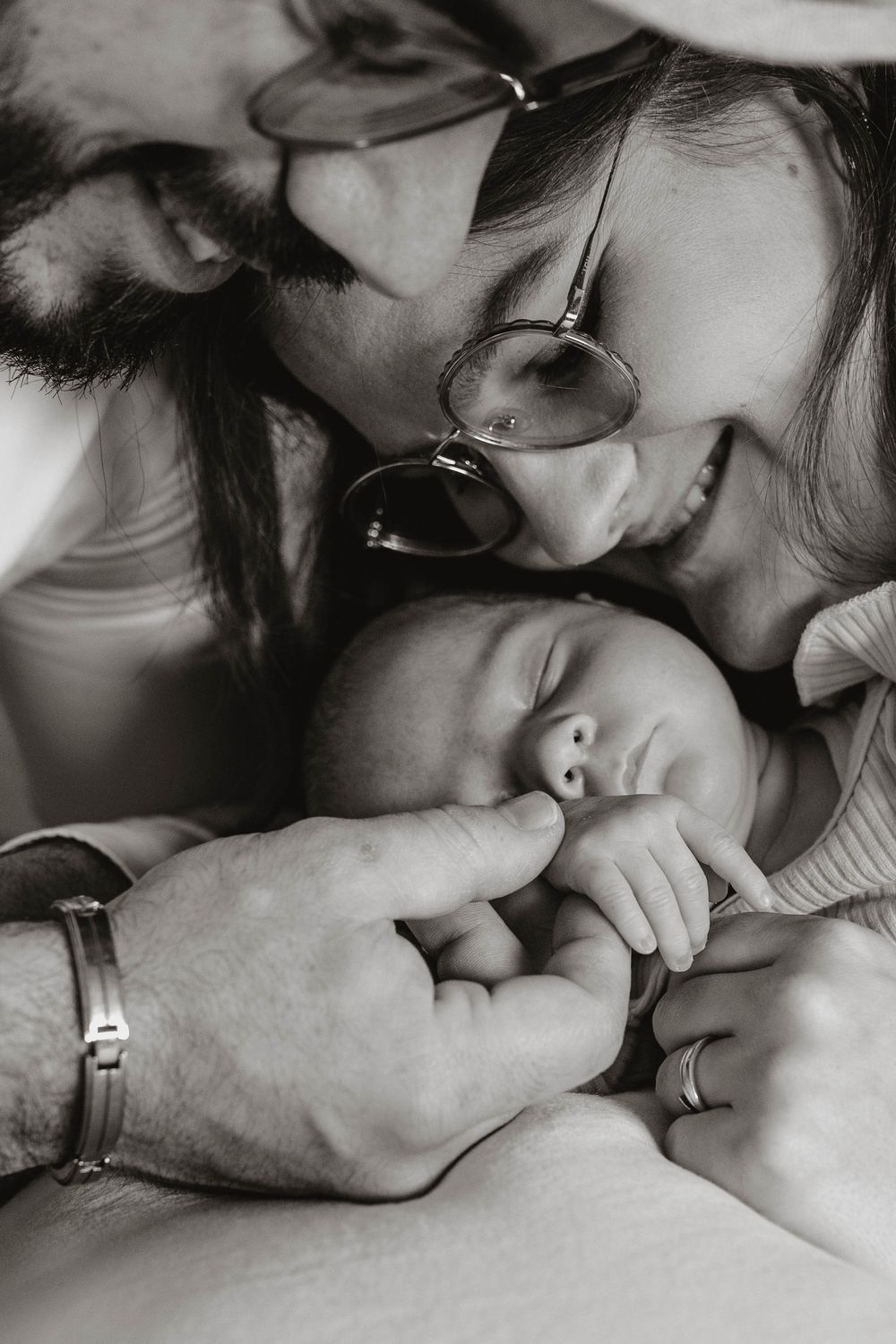 Black and white intimate close-up photos showing tender moments of affection and connection between people.