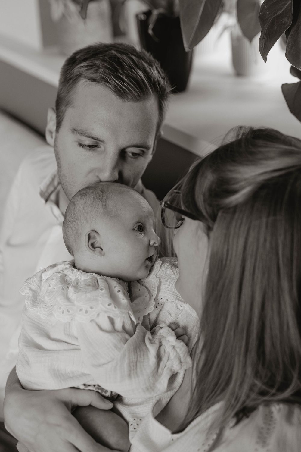 A series of black and white photos showing intimate moments between a couple in a romantic sequence.