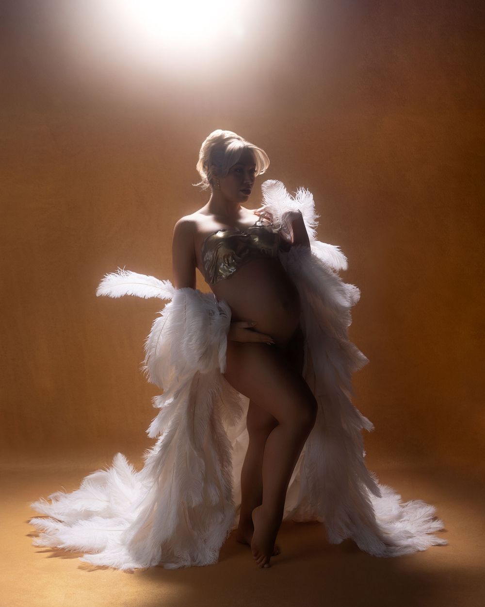 Artistic photo series showing contrasting figures in silhouette against ethereal white tulle fabric in dreamy brown lighting.